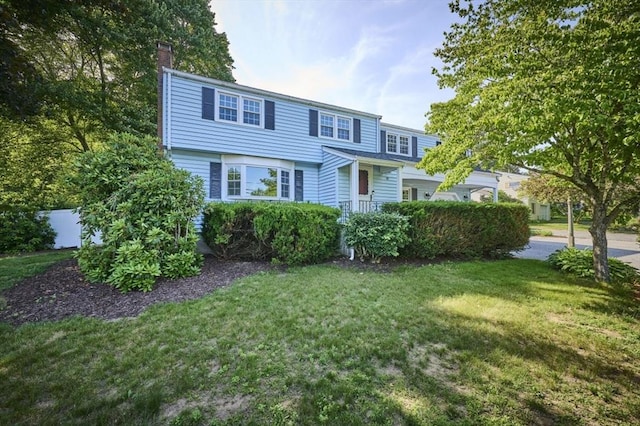 10 Locust St, Burlington, MA 01803 - view of front of house with a front yard and a chimney