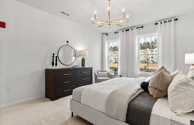 carpeted bedroom with a notable chandelier