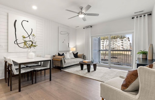 living room featuring hardwood / wood-style floors and ceiling fan