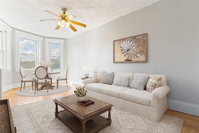 living room featuring hardwood / wood-style floors, a textured ceiling, and ceiling fan