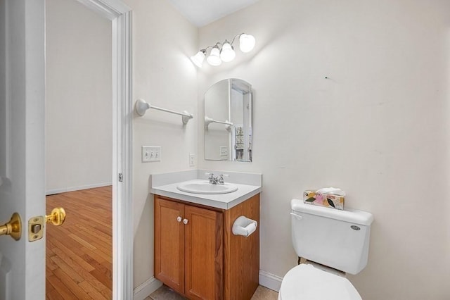 30 Horne Way Unit 30, Millbury, MA 01527 - bathroom with toilet, vanity, wood finished floors, and baseboards