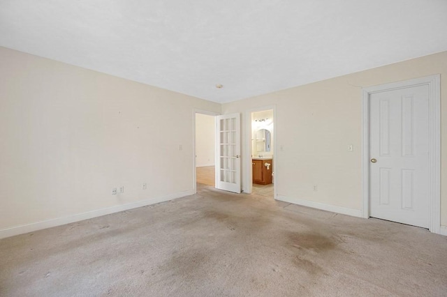 30 Horne Way Unit 30, Millbury, MA 01527 - unfurnished bedroom with baseboards, light carpet, and ensuite bath