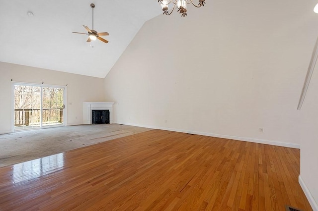 30 Horne Way Unit 30, Millbury, MA 01527 - unfurnished living room with high vaulted ceiling, a chandelier, a fireplace, a ceiling fan, and light wood finished floors