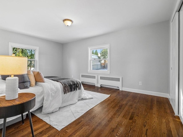 bedroom with wood-type flooring and radiator