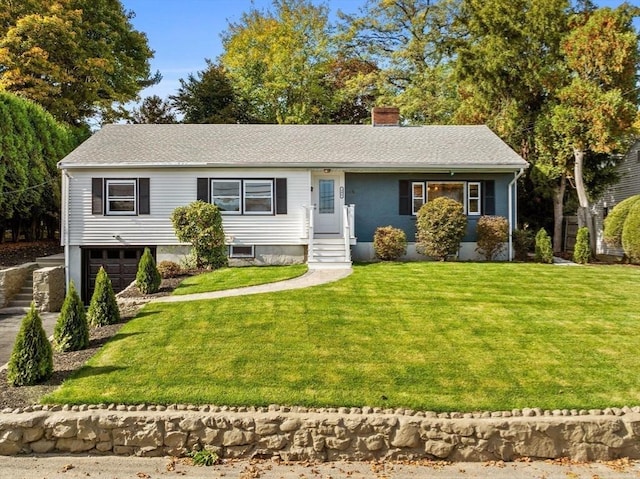 view of front of property featuring a garage and a front lawn