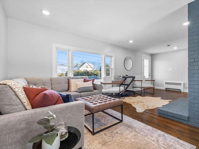 living room featuring radiator and hardwood / wood-style floors