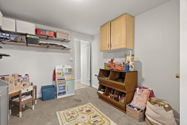 game room with baseboards and light carpet
