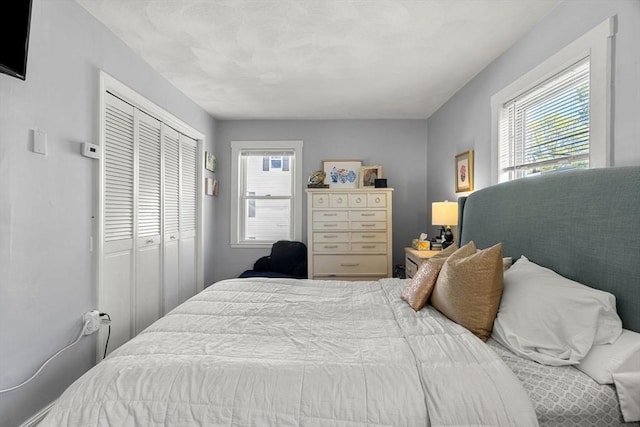 bedroom featuring multiple windows and a closet