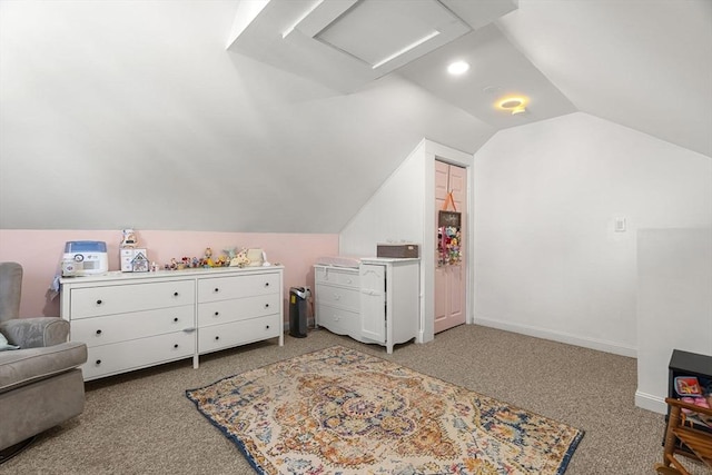 bedroom featuring baseboards, vaulted ceiling, light carpet, and attic access