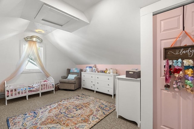 bedroom featuring attic access, lofted ceiling, and light carpet