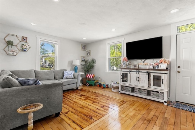 living area with recessed lighting and hardwood / wood-style flooring