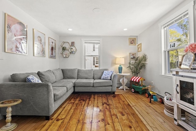 living room featuring plenty of natural light, wood-type flooring, and recessed lighting