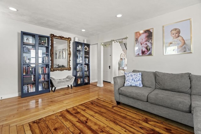 living room with baseboards, wood-type flooring, and recessed lighting