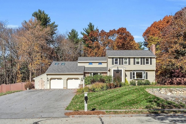 view of front of property with a garage and a front lawn