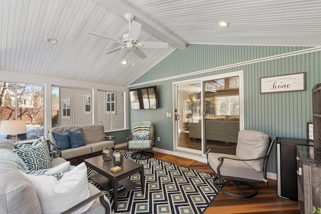 sunroom with ceiling fan, plenty of natural light, and lofted ceiling with beams