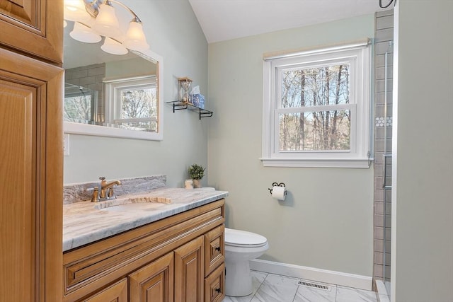 bathroom featuring vanity, toilet, and walk in shower