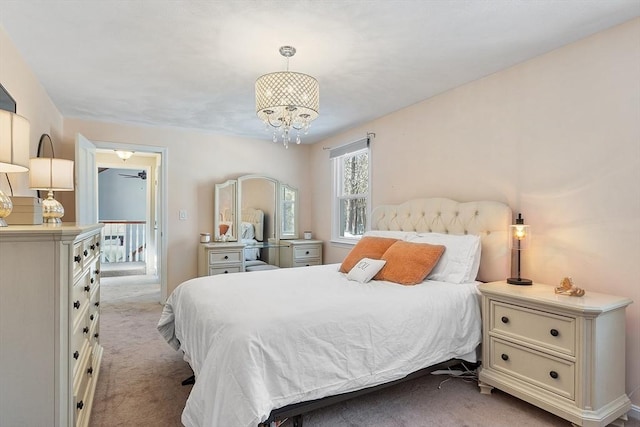 carpeted bedroom featuring a notable chandelier