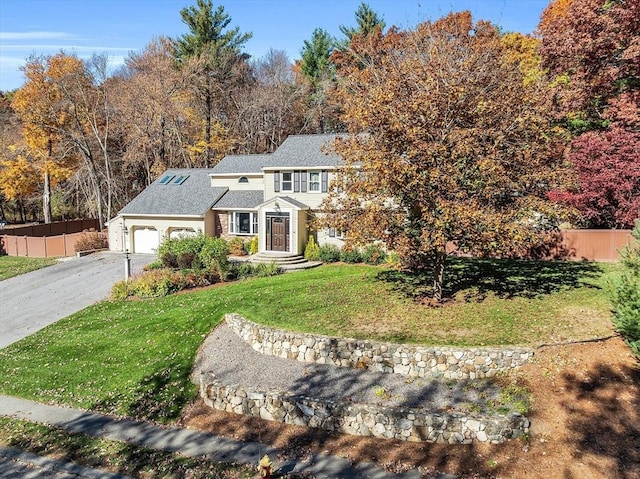 view of front of home with a garage and a front yard