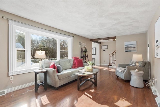 living room with a textured ceiling, plenty of natural light, and wood-type flooring