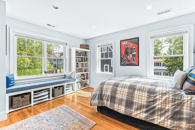 bedroom featuring multiple windows, wood finished floors, and recessed lighting