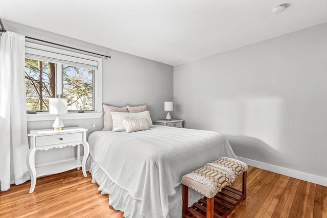 bedroom featuring light wood-type flooring and baseboards