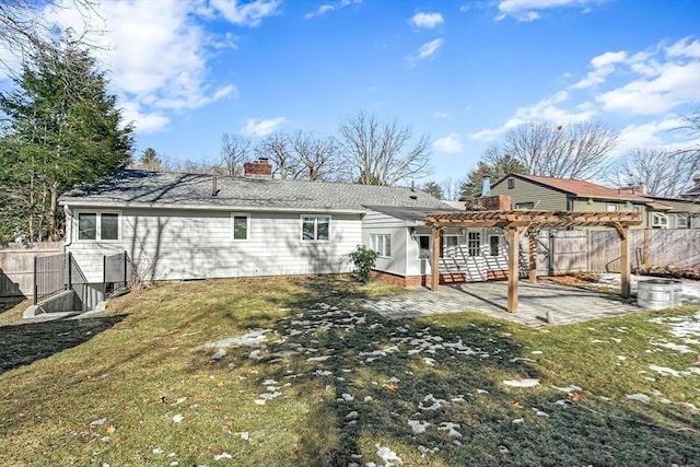 rear view of property with a yard, a patio area, fence, and a pergola