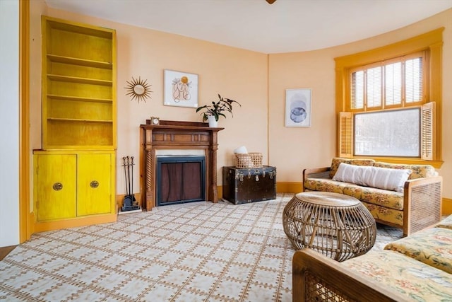 living room with a fireplace and built in shelves