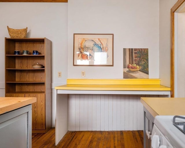 interior space with dark wood-type flooring and white range with gas stovetop