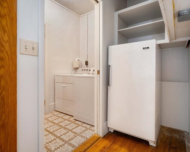 bathroom with wood finished floors and washer and clothes dryer