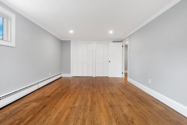 unfurnished bedroom featuring crown molding, a baseboard radiator, and hardwood / wood-style flooring