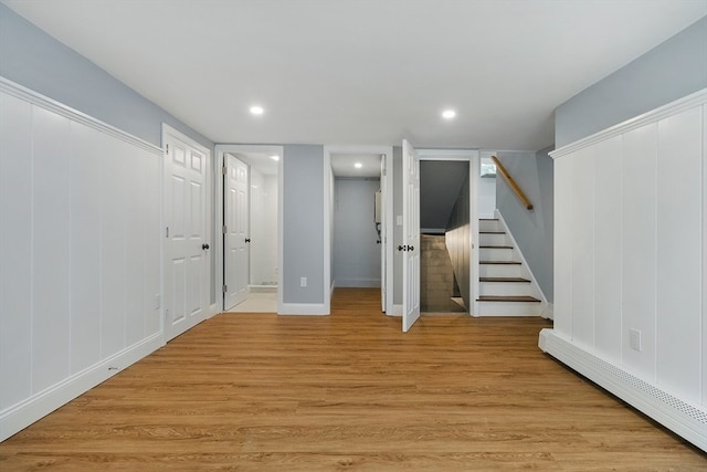 interior space featuring light hardwood / wood-style floors and a baseboard radiator