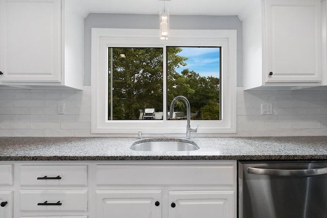 kitchen featuring sink, tasteful backsplash, stainless steel dishwasher, decorative light fixtures, and white cabinetry