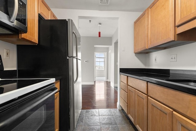 80 Wingate St Unit 3C, Haverhill, MA 01832 - kitchen with stainless steel microwave, range, dark countertops, and baseboards