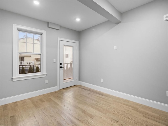 interior space with beamed ceiling and light hardwood / wood-style floors