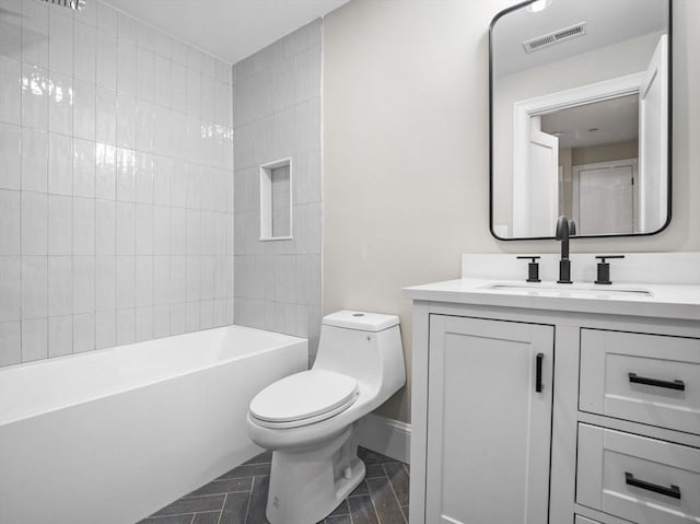 full bathroom with vanity, toilet, and tiled shower / bath combo