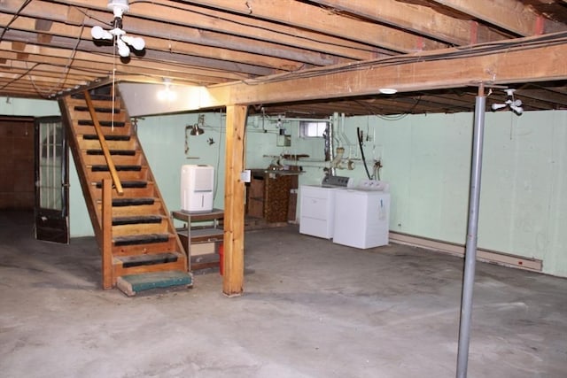 basement featuring stairs and washing machine and clothes dryer