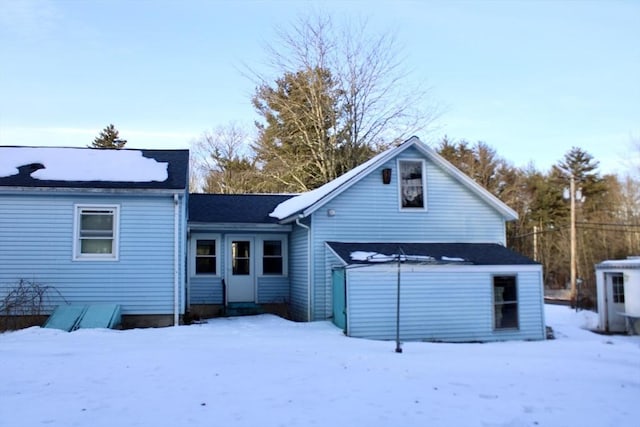 snow covered property featuring entry steps