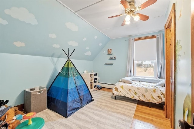 bedroom featuring vaulted ceiling, wood-type flooring, a ceiling fan, and a baseboard heating unit