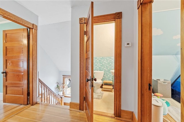 interior space featuring an upstairs landing and wood finished floors