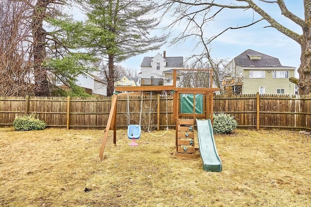 view of playground with a residential view and a fenced backyard