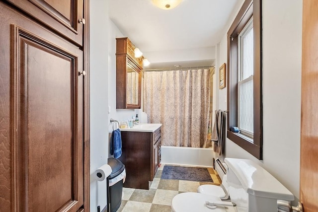 full bath featuring toilet, tile patterned floors, shower / tub combo, and vanity