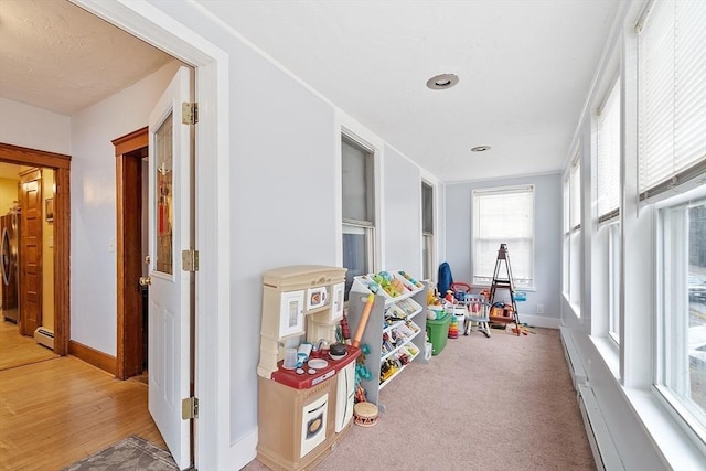rec room with washer / dryer, baseboards, baseboard heating, and recessed lighting