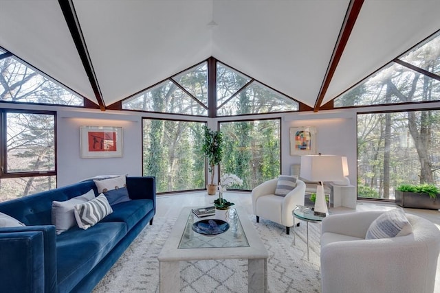 living room featuring vaulted ceiling with beams, plenty of natural light, and hardwood / wood-style floors