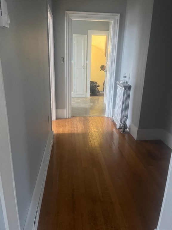 hallway with hardwood / wood-style floors