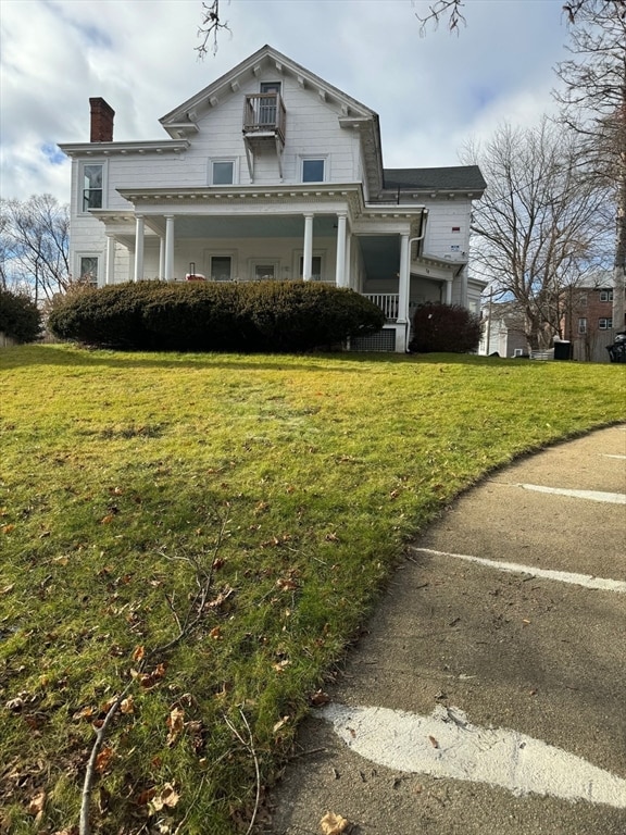 view of front of home with a front yard and a porch