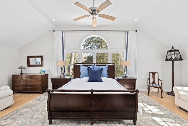 bedroom featuring vaulted ceiling, light wood-type flooring, a ceiling fan, and baseboards