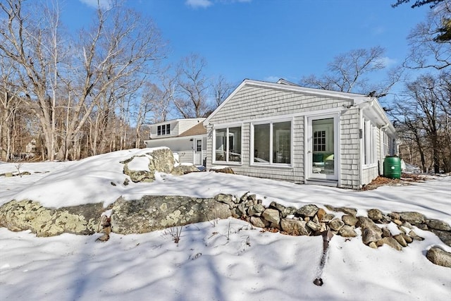 view of snow covered rear of property