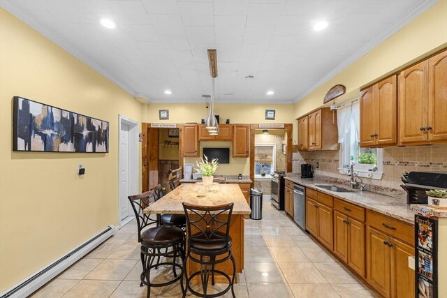 39 Crapo St, New Bedford, MA 02740 - kitchen with a baseboard radiator, appliances with stainless steel finishes, a breakfast bar area, tasteful backsplash, and a center island