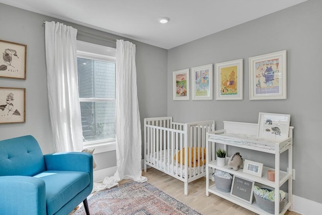 27 Central Rd Unit 1, Somerville, MA 02143 - bedroom with wood finished floors and a crib