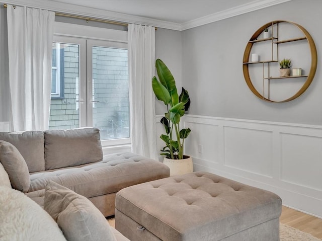 27 Central Rd Unit 1, Somerville, MA 02143 - living area featuring crown molding, wood finished floors, wainscoting, french doors, and a decorative wall